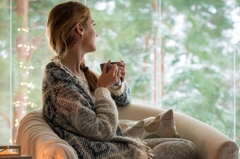 Woman keeping warm in the winter with a warm shawl.