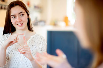 Two teenage girls having a conversation using sign language