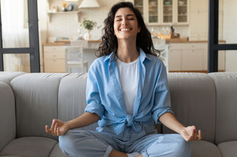 A woman is practicing mindfulness and feeling joyful.