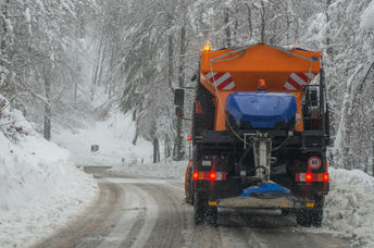 DE-icing truck on a snow-covered road.