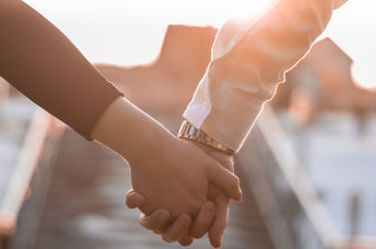 A couple holding hands.