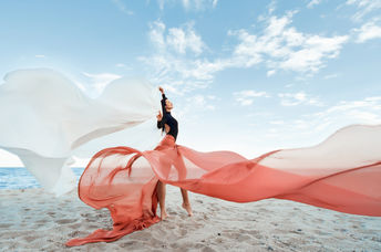 Classic dancer at the beach with long, flowing fabric
