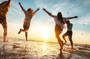Four happy friends enjoying the beach.