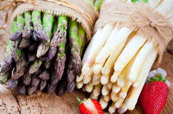 Bunches of fresh green and white asparagus.