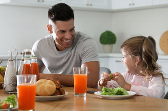 Father and daughter enjoying a healthy breakfast together.