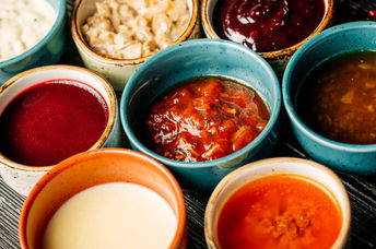 Bowls of various healthy vegan condiments.