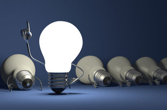 Glowing light bulb character in moment of insight.