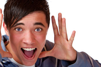 Teen holding his hands by his head and announcing interesting news.