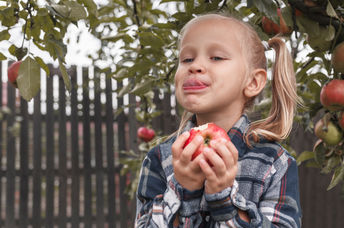 A girl is eating new food.