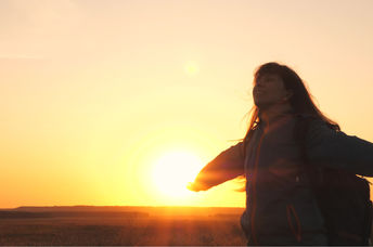 A happy girl closes her eyes.