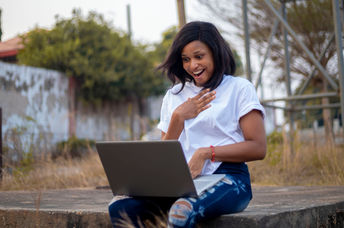 A young woman sitting with her laptop.