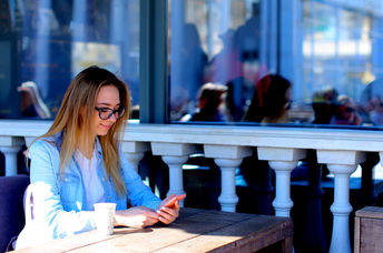 Young woman using her smartphone to boost productivity.