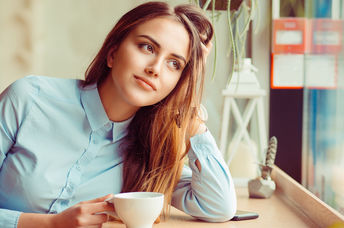 A young woman sitting in a cafe.