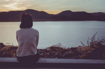 A woman looking at the lake.