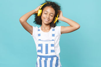 Cute kid enjoying music.