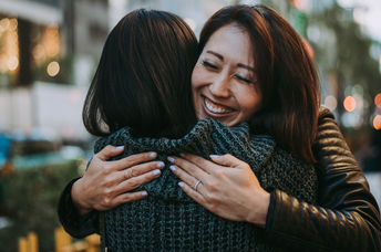Two women hugging.