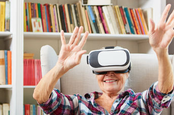 Senior citizen enjoys using VR glasses