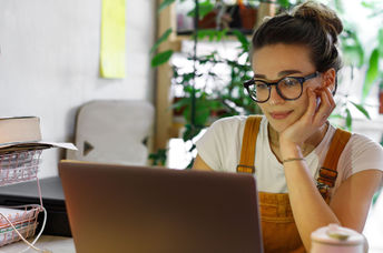 A young woman typing on a computer.