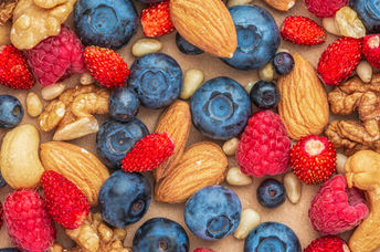 Nuts and berries are healthy foods to eat daily.