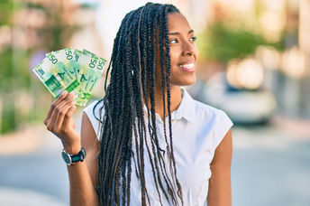 Young woman holding banknotes.