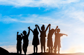 Silhouette of a group of children.