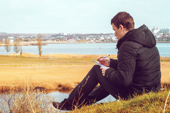 A young man writing a poem.