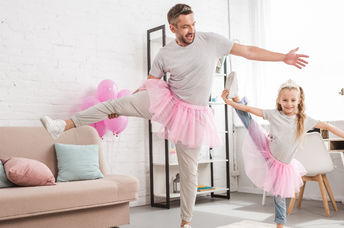 Father and daughter in pink tutu skirts.