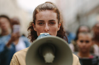 A woman protesting with a megaphone.