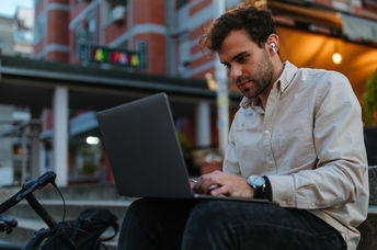 A young man typing on a computer.