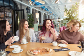 Female friends enjoying themselves in a cafe.