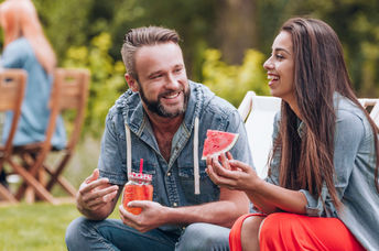 Enjoying watermelon at a summer barbeque.