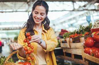 Buying tomatoes at a farmers market.
