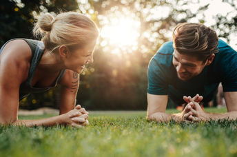 Couple exercising in their backyard.