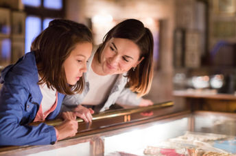 Mother and daughter exploring a museum.