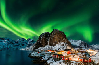 Aurora borealis over Hamnoy in Norway .