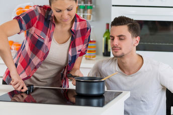 Young woman cooking with her boyfriend.