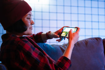 Playing  game on a cellphone.