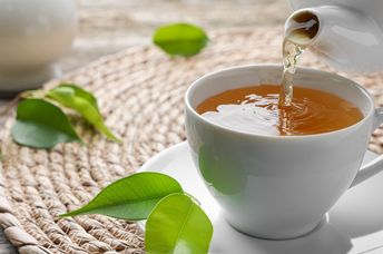 Pouring a cup of green tea.