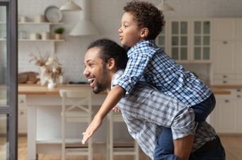 Dad hugging his disabled son.
