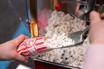 Old fashioned popcorn makers are a hit at a party.
