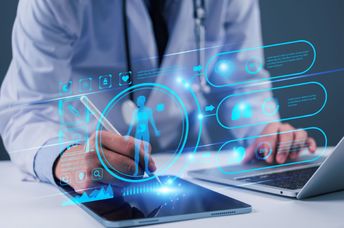 A doctor uses technology.