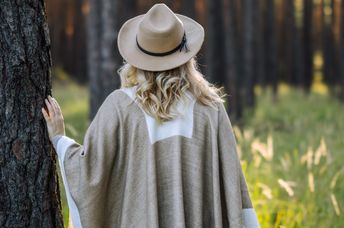 Woman contemplating the stillness of the forest.