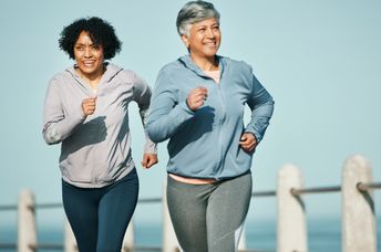 Senior women running on a boardwalk.