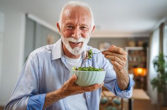 A man eats a salad.