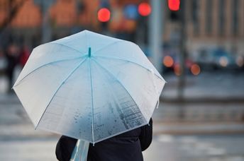 Using an old-fashioned umbrella on a rainy day.
