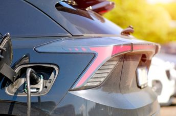 Electric vehicle charging in a residential neighborhood.