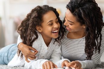 Mother and daughter reading about Black History.