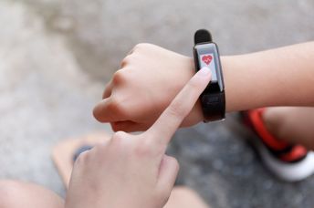 A girl touches a smartwatch.
