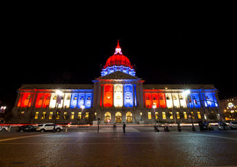 The San Fransisco City Hall glows red white and blue in solidarity with Paris