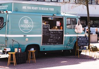 A food truck of the instock restaurant stands by the street